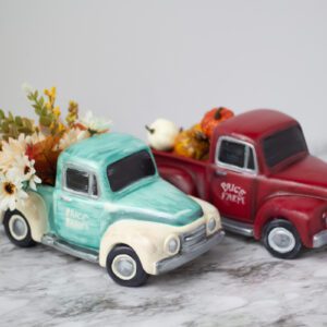A pair of vintage truck figurines with flowers in them.