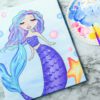 A Sparkly Mermaid on a marble table.