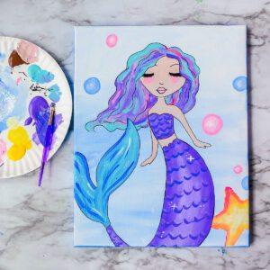 A painting of a Sparkly Mermaid on a marble table.