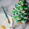 A "Natural" Ceramic Lit Christmas Tree Kit on a plate with a paint brush.