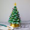 A "Natural" Ceramic Lit Christmas Tree Kit on a table next to a paint brush.