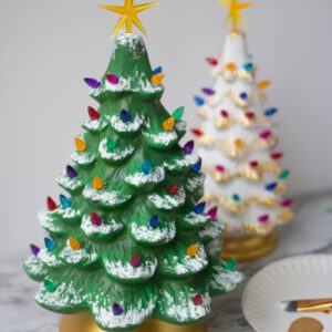 Two "Natural" Ceramic Lit Christmas Tree Kits on a table next to a paintbrush.