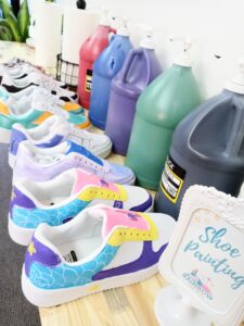 A table full of shoes painted with different colors.