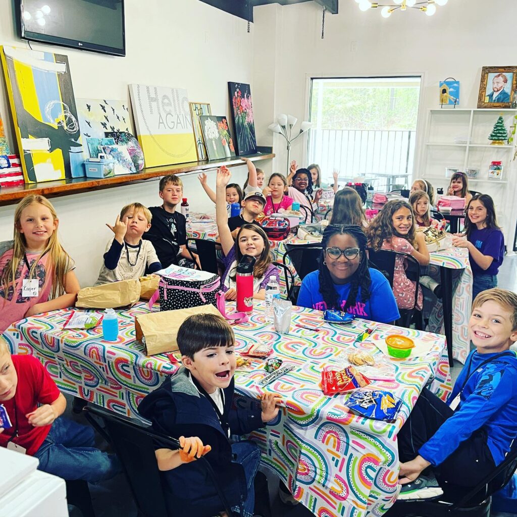 A group of children posing at a table.