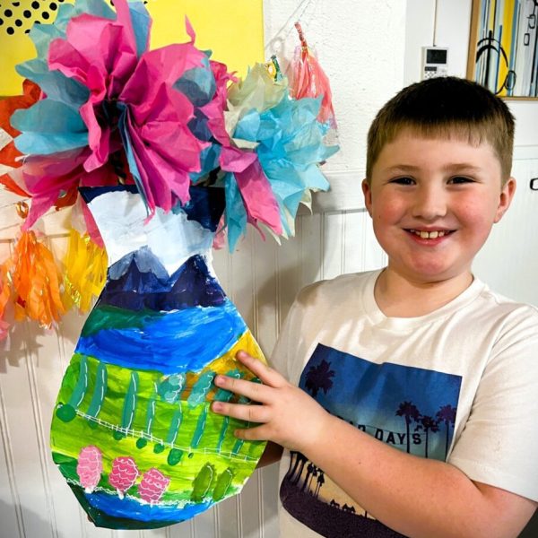boy showing off art project