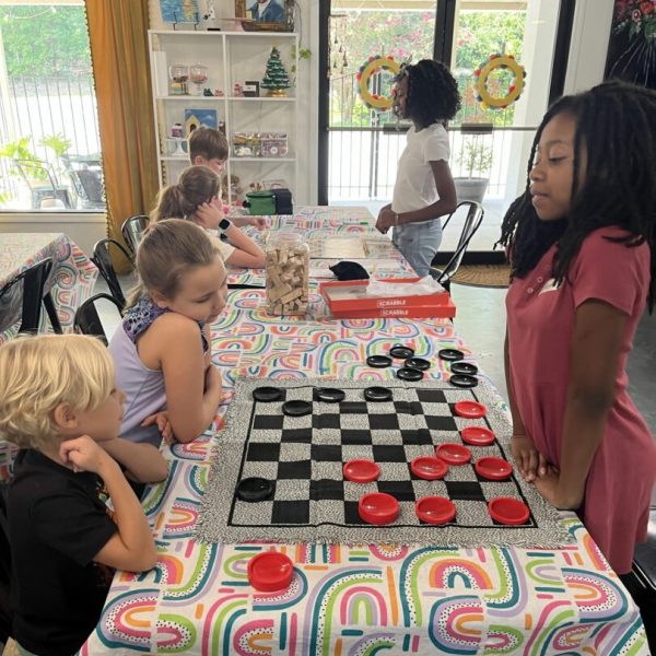 A group of children playing chess at a table.